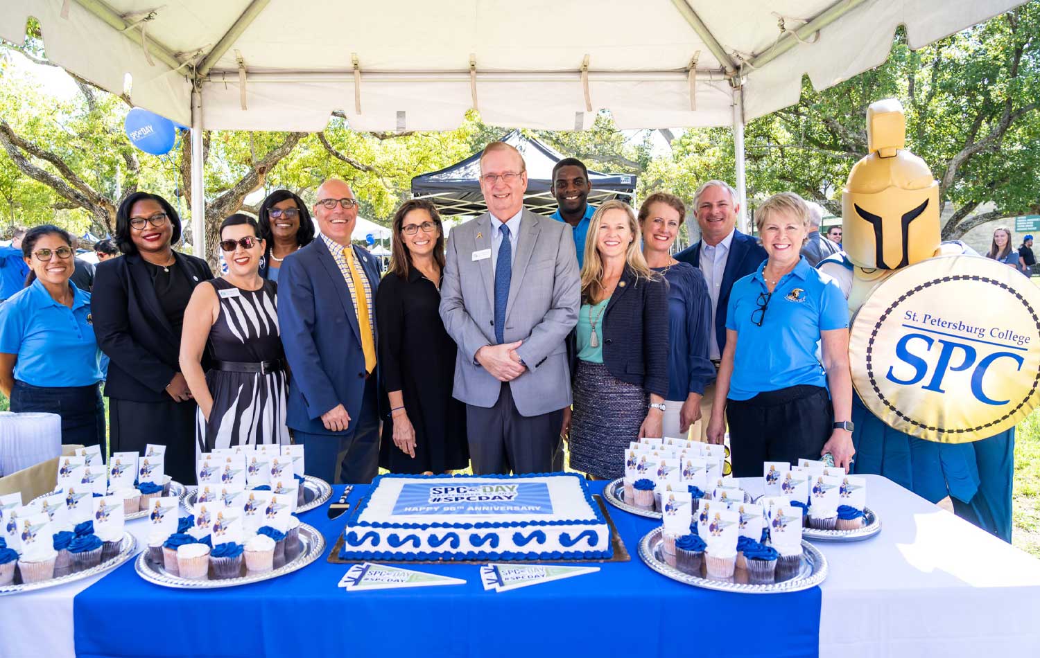 SPC day gathering in front of table with promo items