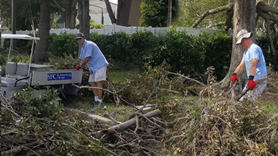 SPC facilities crew cleaning up fallen branches from storm damage