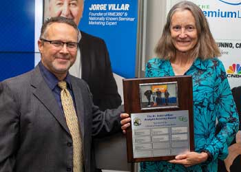 Dr. Robin Wilber receiving capstone award holding plaque