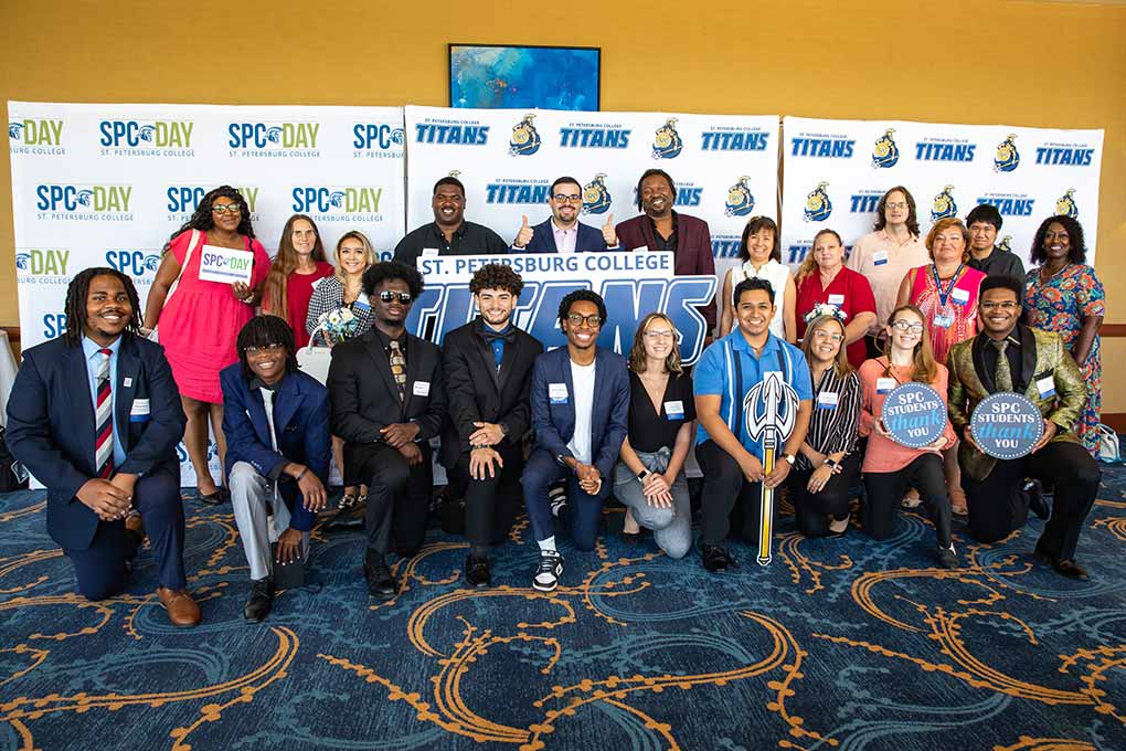 Many SPC students and staff posing in front of SPC Day banners, holding signs thanking the scholorship donors