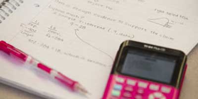 image of a calculator and a notepad