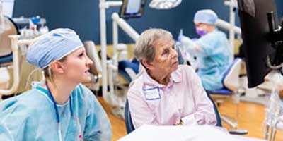 a professor observing a dental hygiene student in the lab