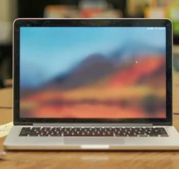 A laptop computer showing an out-of-focus mountain.