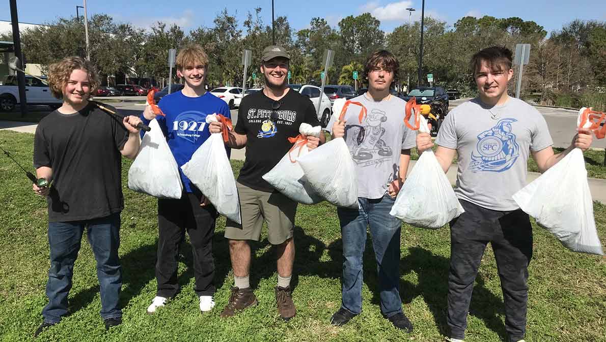 group of collegiate high school student picking up trash at Gibbs Campus