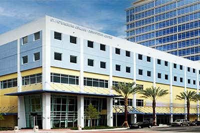 A view of the colorful SPC Downtown Center building under a blue sky.