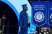 SPC graduate walking on graduation stage