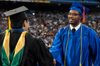 graduation student receiving diploma from faculty