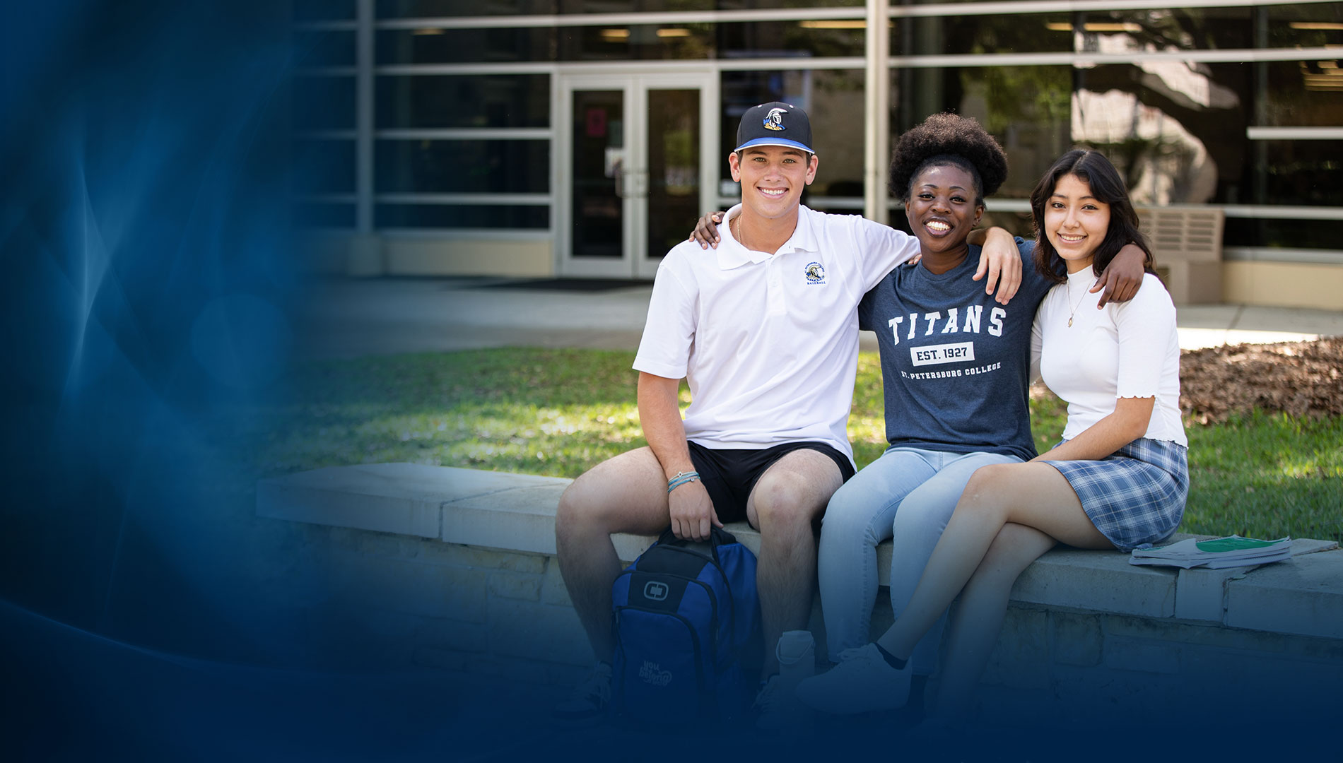 three SPC students sitting on a concrete bench smiling